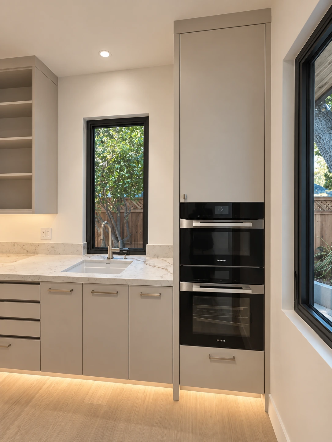 Click to view full screen Butler's pantry with paneled ovens and marble counters