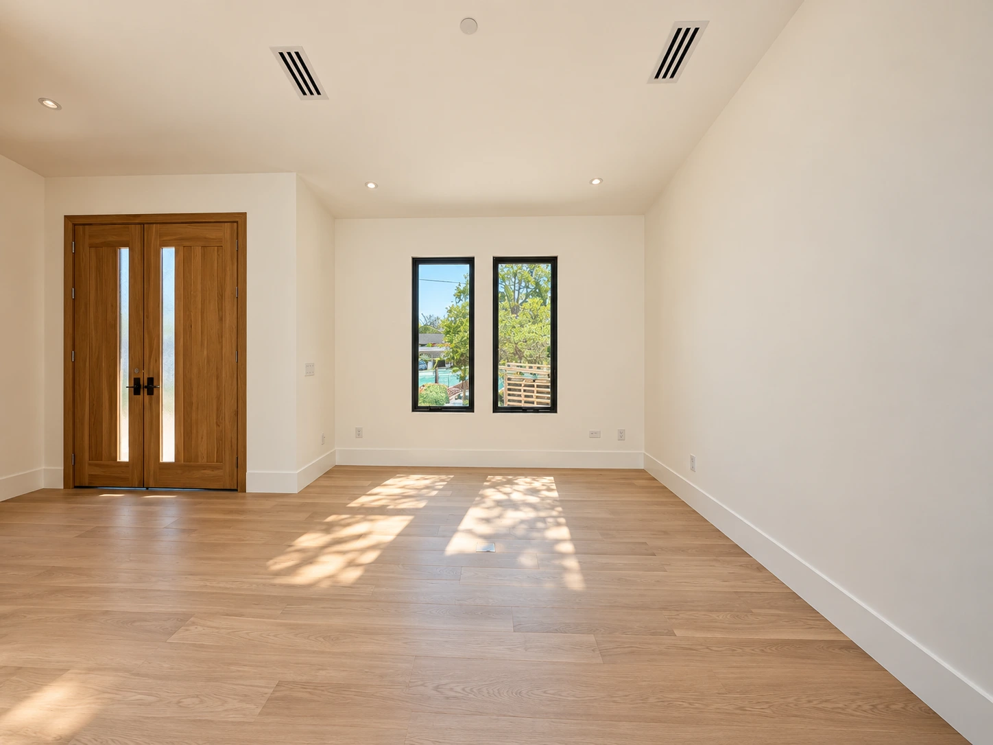 Click to view full screen Sunlit room with double entry doors and tall side windows
