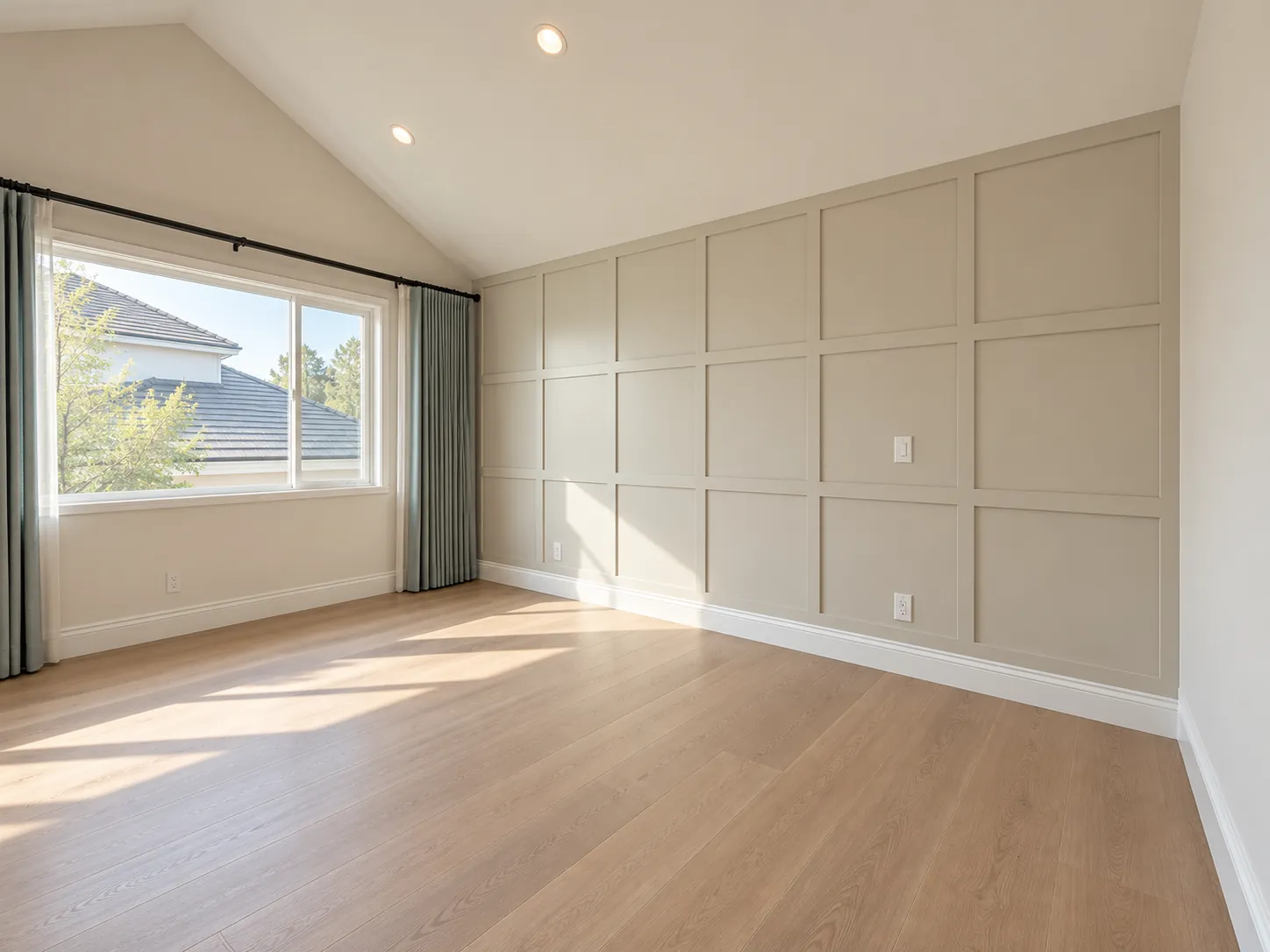 Bedroom with vaulted ceiling and paneled wall
